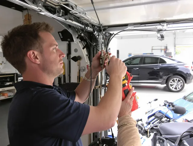Manchester Garage Door Repair safety certified technician performing cable replacement in Manchester