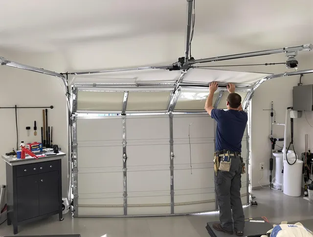 Manchester Garage Door Repair specialist performing precise section replacement on Manchester garage door
